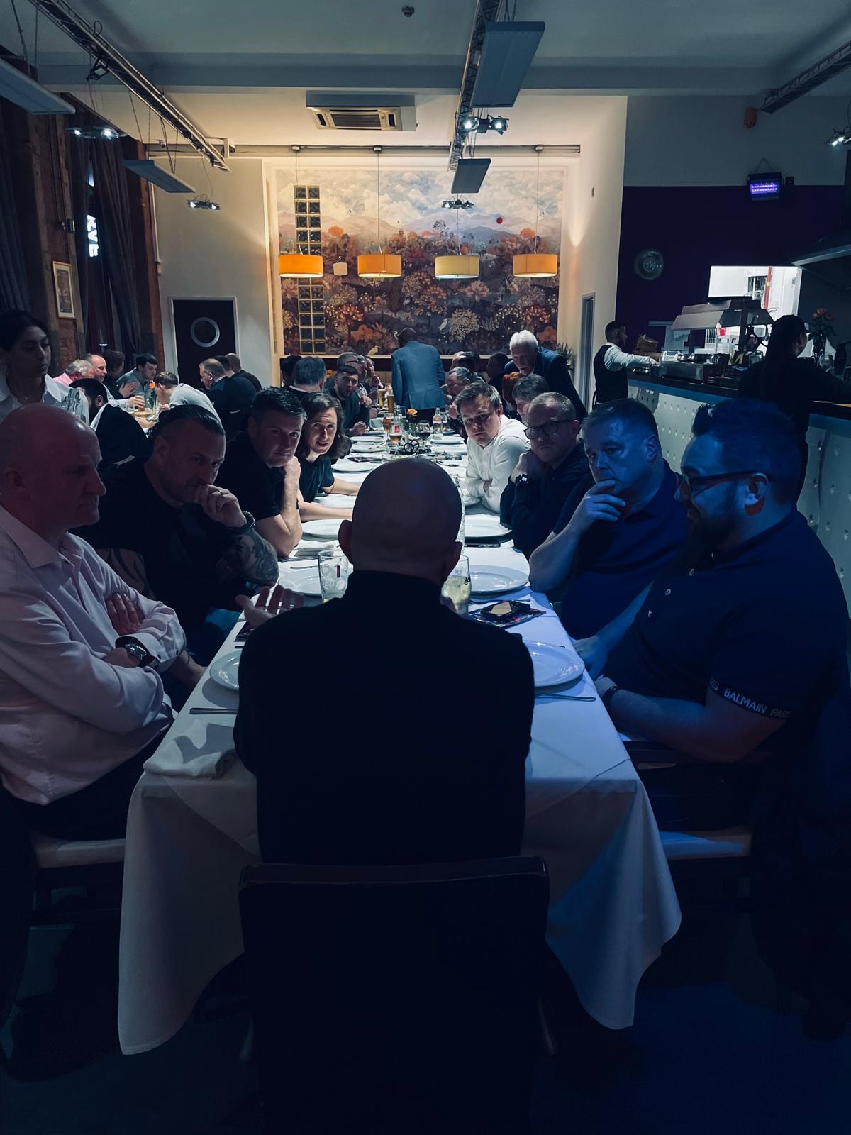 Guests gathered around the table at a YCGS community event